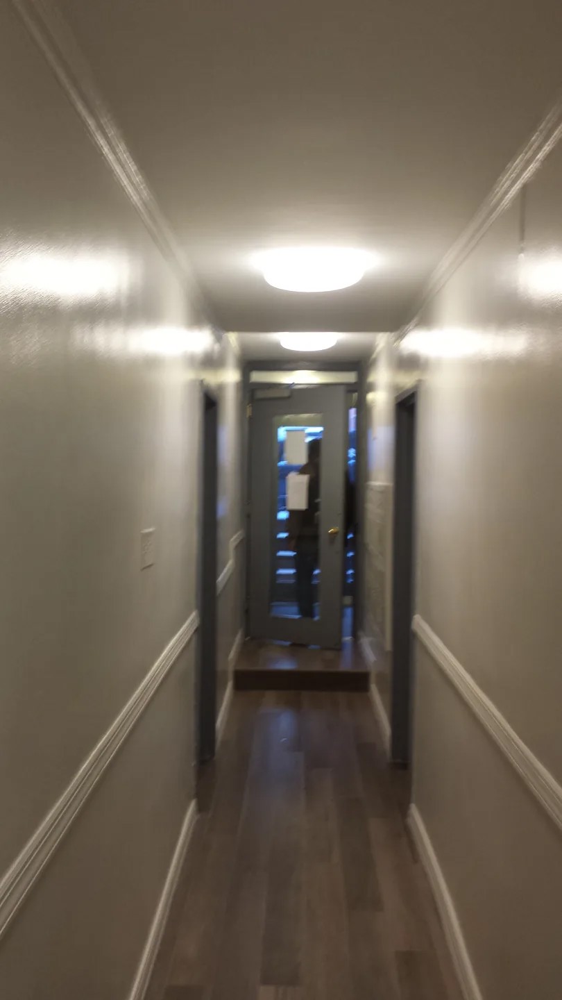 Manhattan multifamily hallway with decorative wall trim and tile flooring photographed in January 2015.