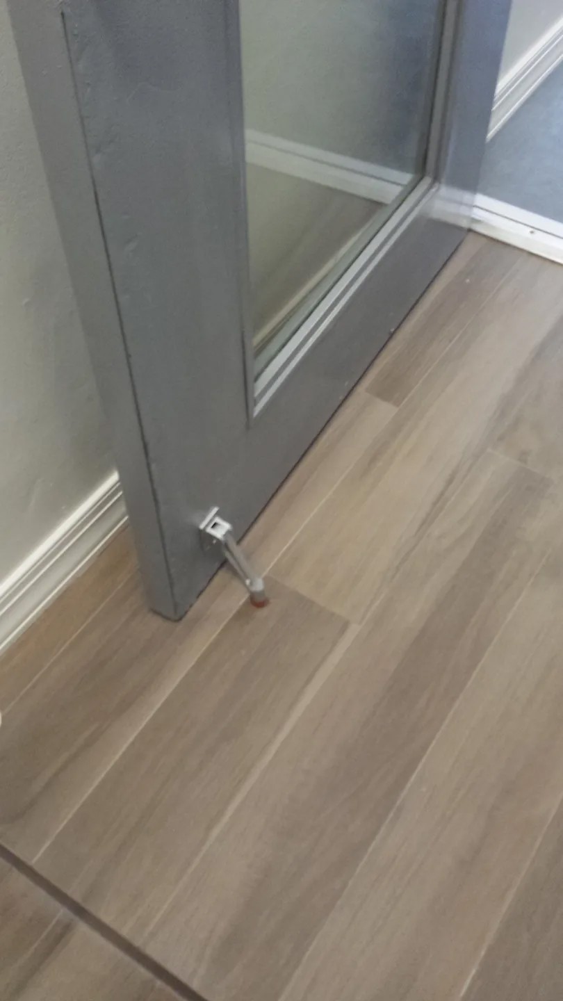 Detail of common hallway floor finish and door threshold in a Manhattan multifamily building.